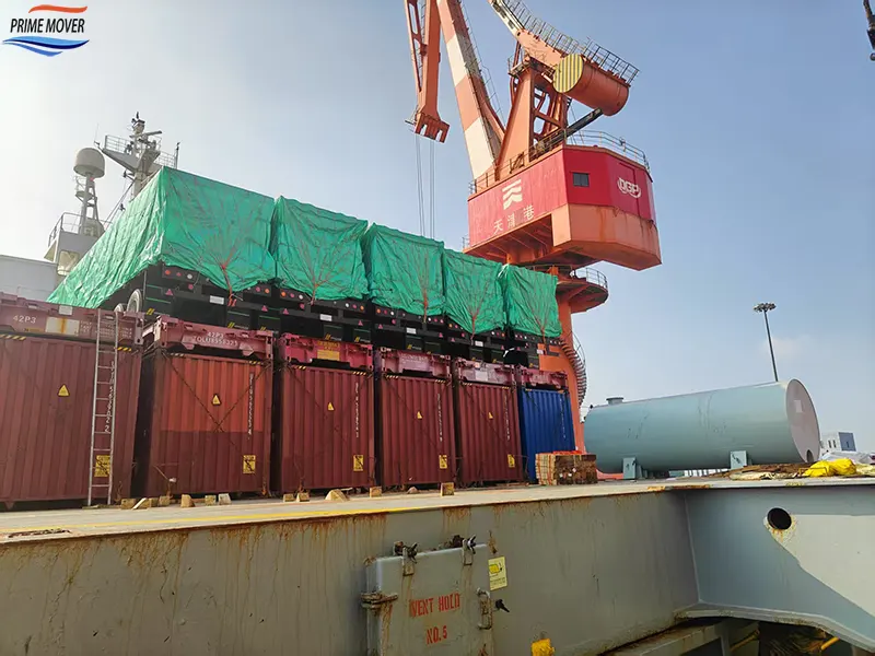 Loading the Three-Axle Flatbed Trailer onto the Ship at the Port Loading the Three-Axle Flatbed Trailer onto the Ship at the Port