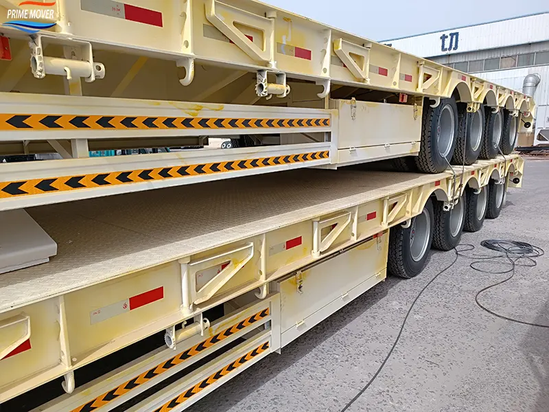4-axle Low-Flatbed Semi-Trailer Being Loaded 4-axle Low-Flatbed Semi-Trailer Being Loaded