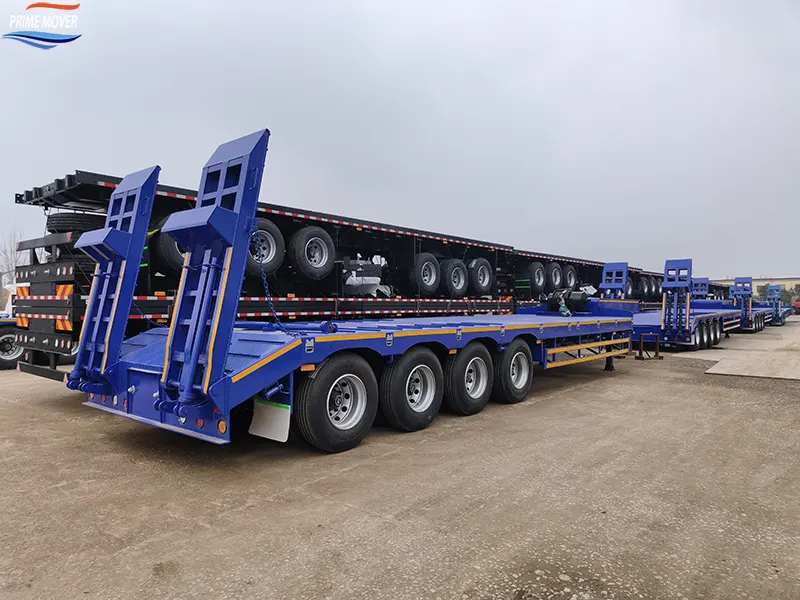 Blue 80-ton Low-Flatbed Semi-Trailer Awaiting Loading Blue 80-ton Low-Flatbed Semi-Trailer Awaiting Loading